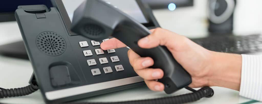 Woman dialing on the voIP Phone